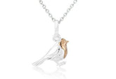 A sterling silver pendant in the shape of a robin bird with a rose gold vermeil accent on its breast, attached to a silver chain.